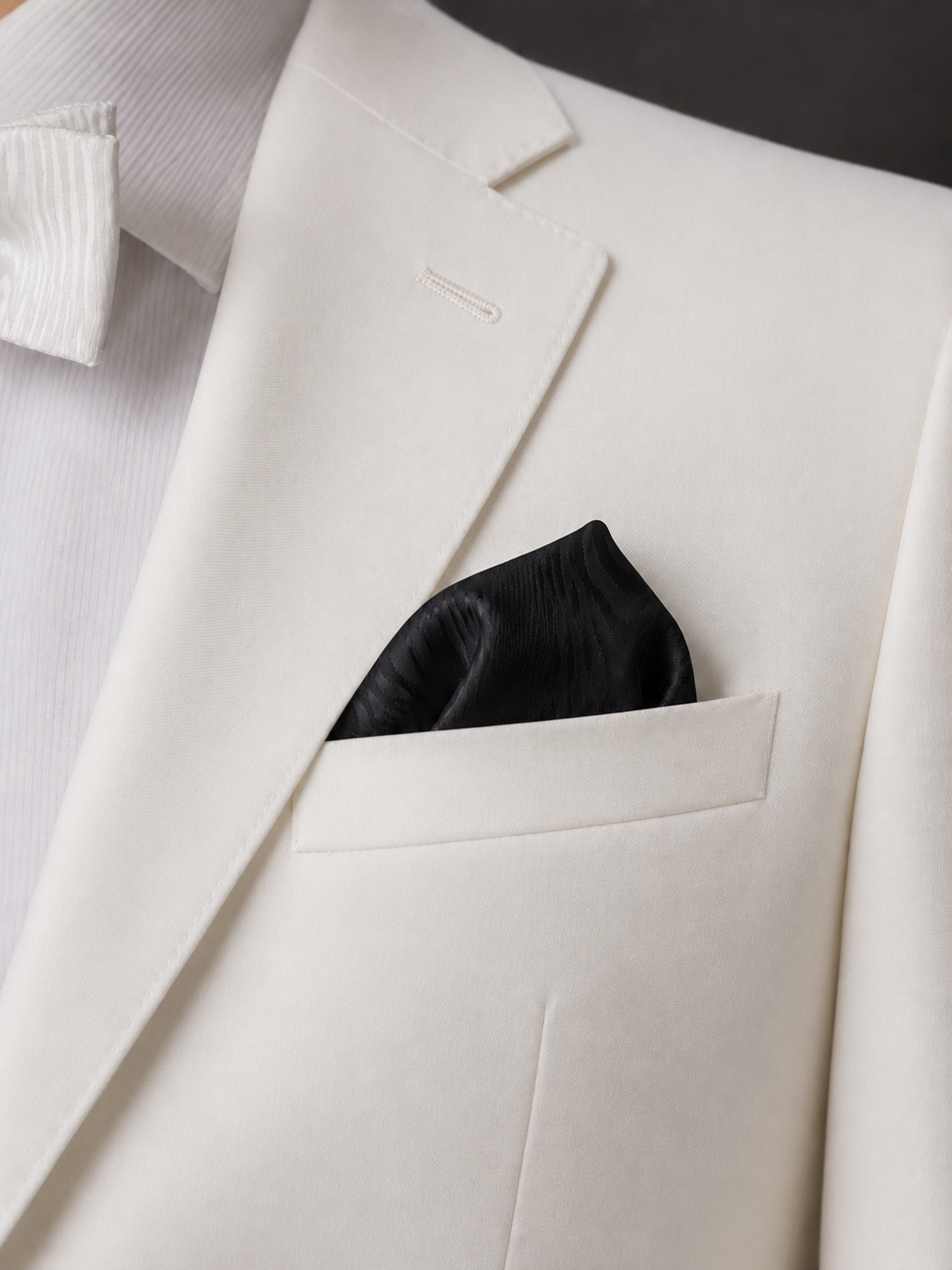 black moire silk pocket square folded with a white blazer