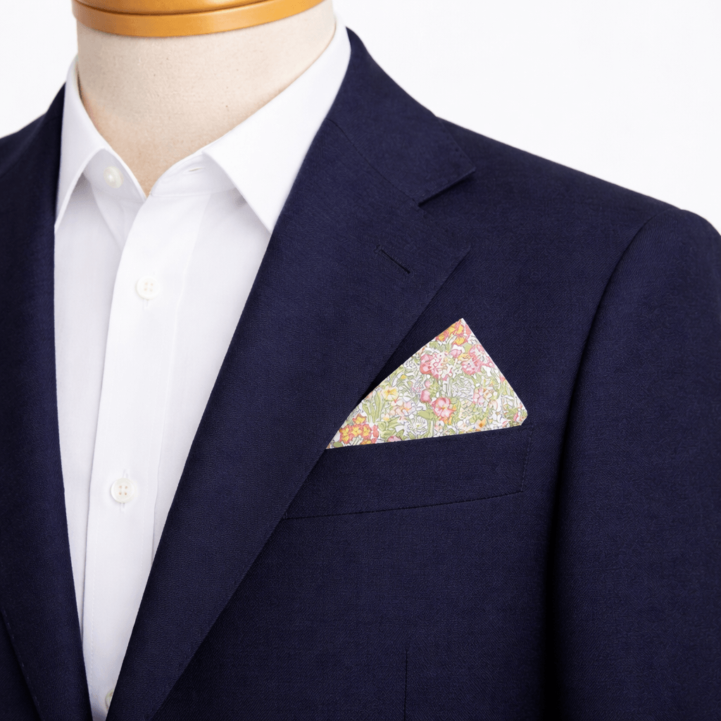 green and pink floral pocket square in a blue blazer
