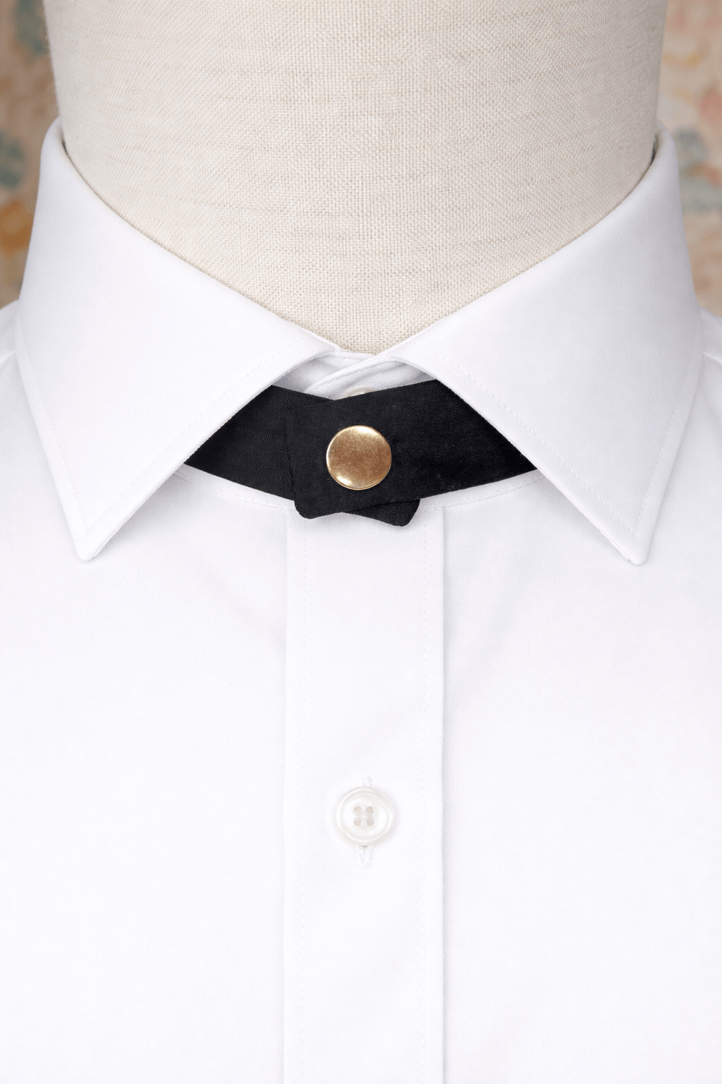 modern continental crossover black silk tie with gold pop stud on a pointed shirt collar