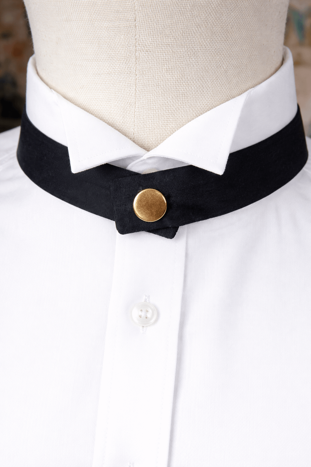 modern continental crossover black silk tie with gold pop stud on a wing shirt collar