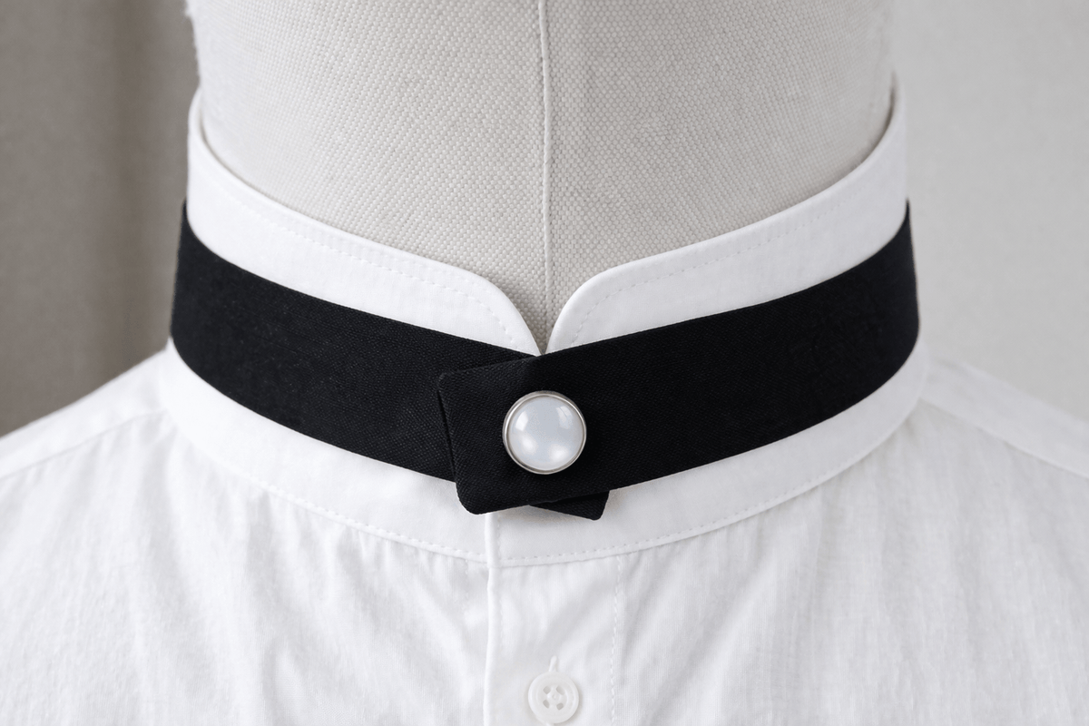 modern continental crossover black silk tie with pearl pop stud on a mandarin shirt collar