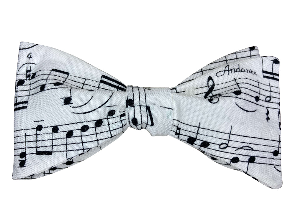 White bow tie with black musical notes on a white background